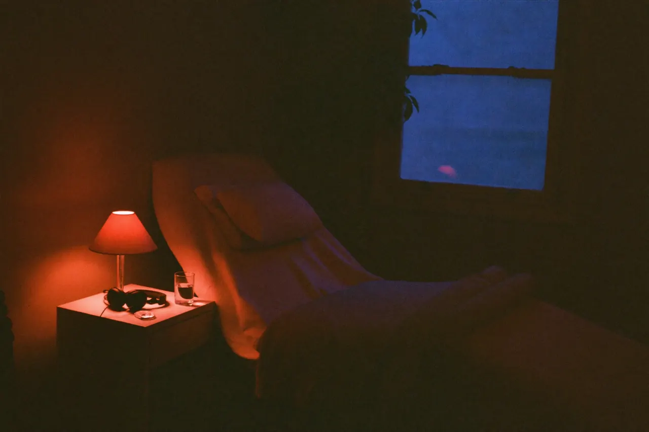 A calm private treatment room with a recliner and a lamp