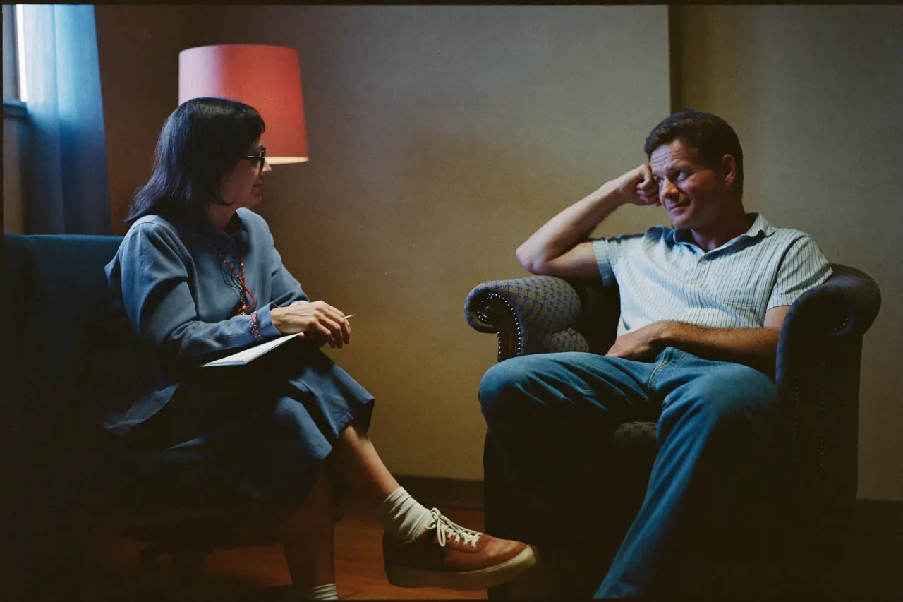 A psychiatrist listening to a patient in a quiet consultation room